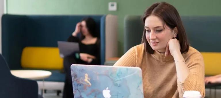 Student sat looking at a laptop 
